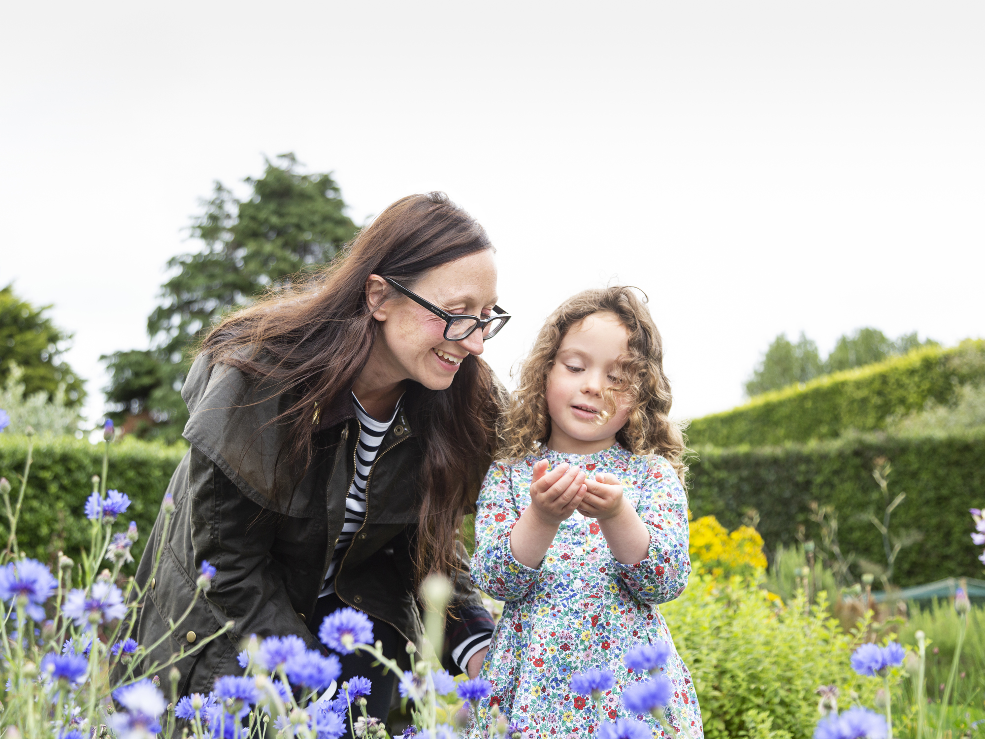 Mother and child looking at flowers 