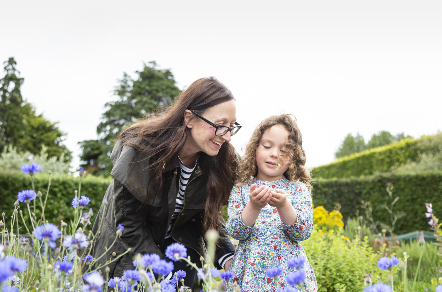 Mother and child looking at flowers 