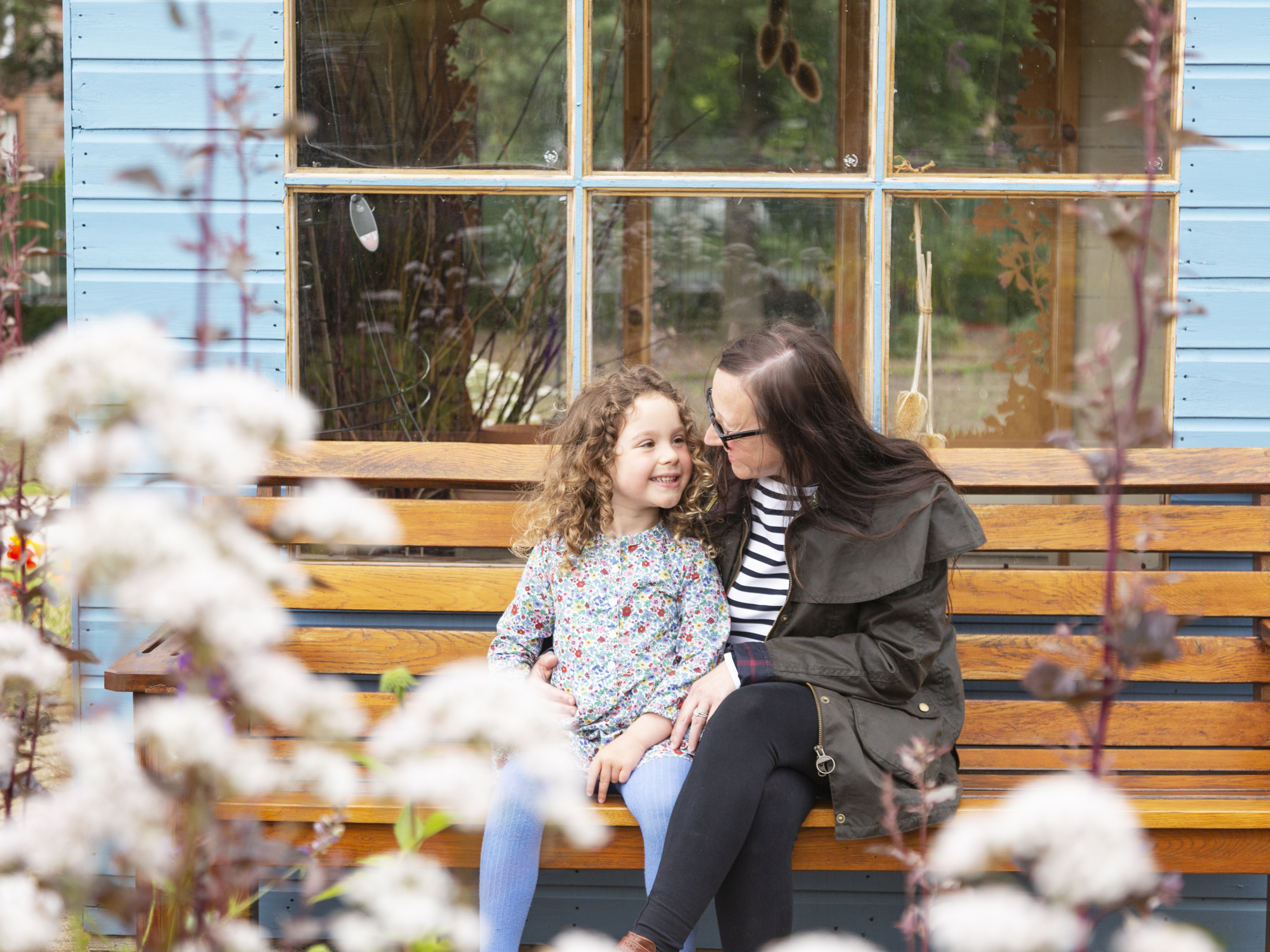 young girl and mother on bench